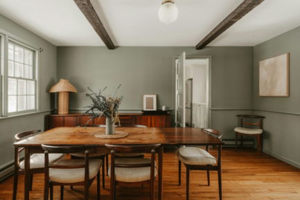A rustic dining room with wooden table and chairs.